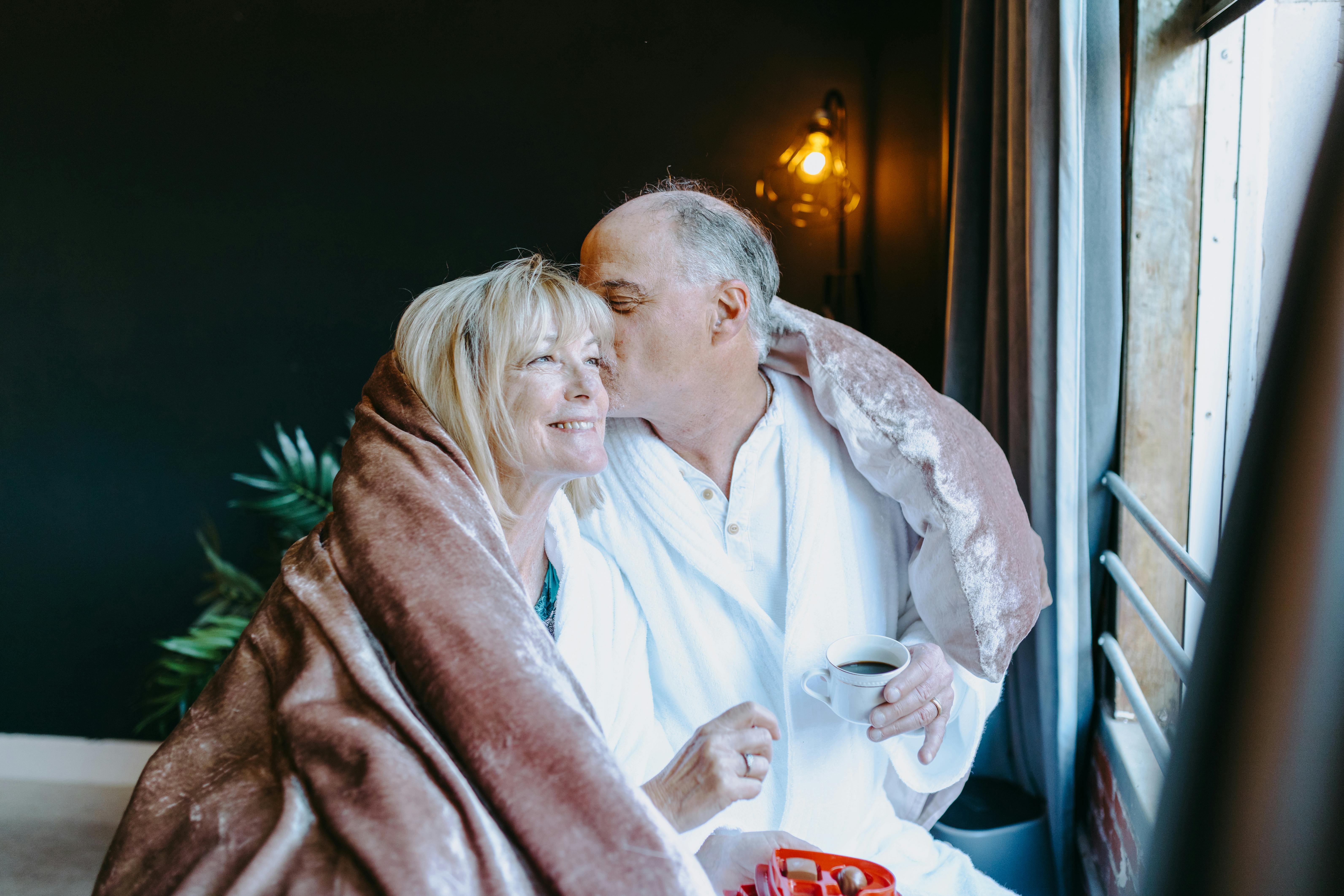 an elderly couple close together, cosy and enjoying their time together on Valentine's Day